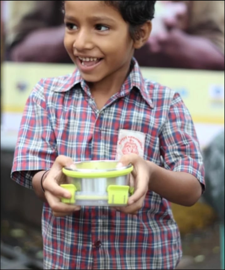 Smiling boy with lunchbox